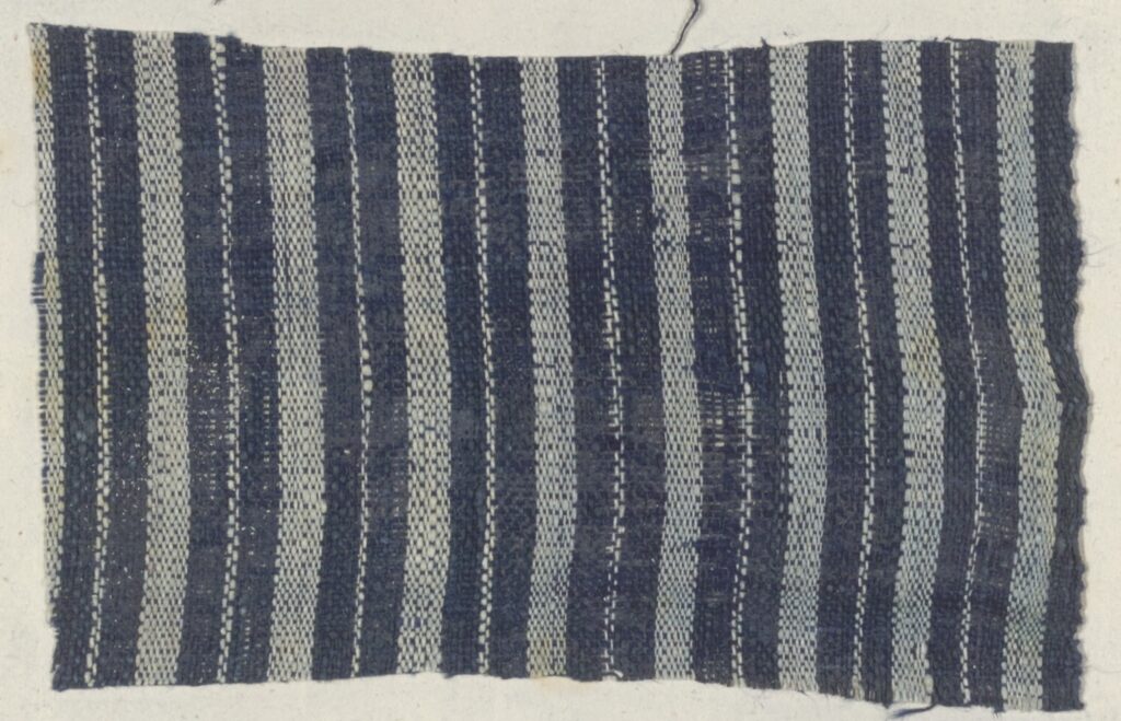 blue cloth with vertical alternating thin and thick white stripes