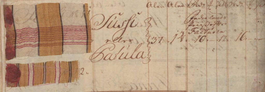 Small pieces of red, white, and yellow cloth, pasted onto a page.